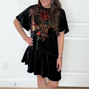 This is a Free People Sweet Echoes black velvet mini dress with a floral design.